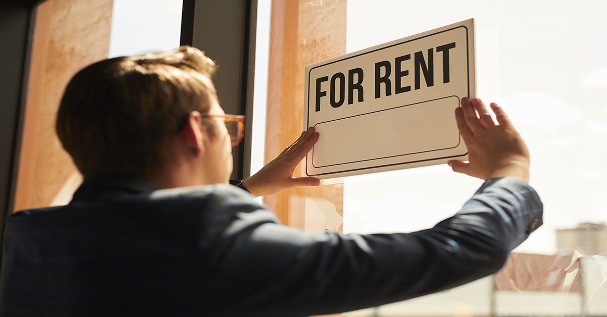 man-holding-for-rent-sign