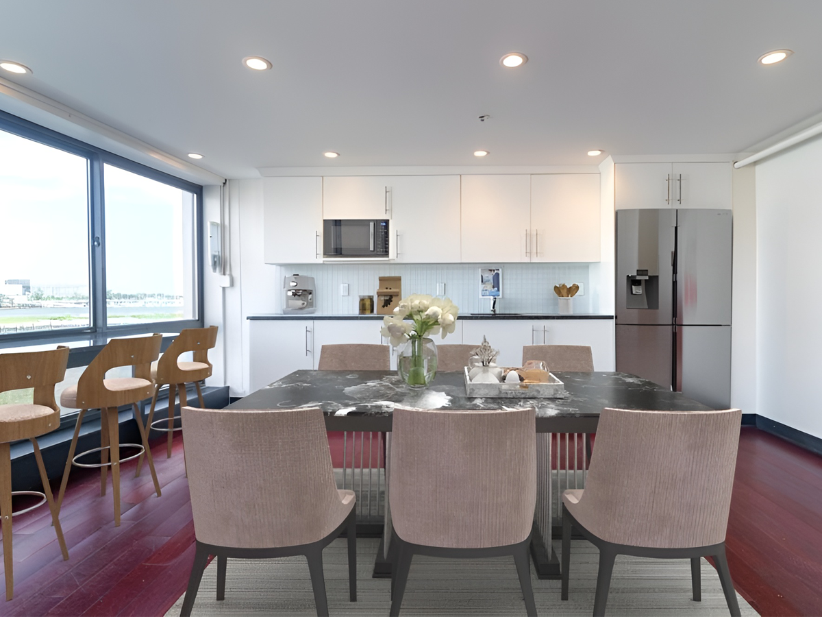 kitchen/break room area staged with table, chairs, bar stools