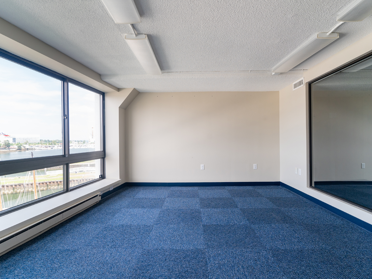 open private office with large window, blue carpet