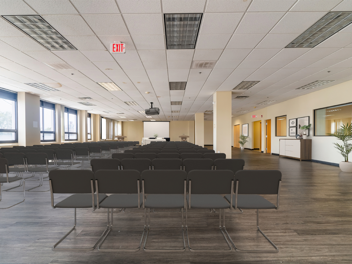 large event area staged with speaker podium, screen, chairs