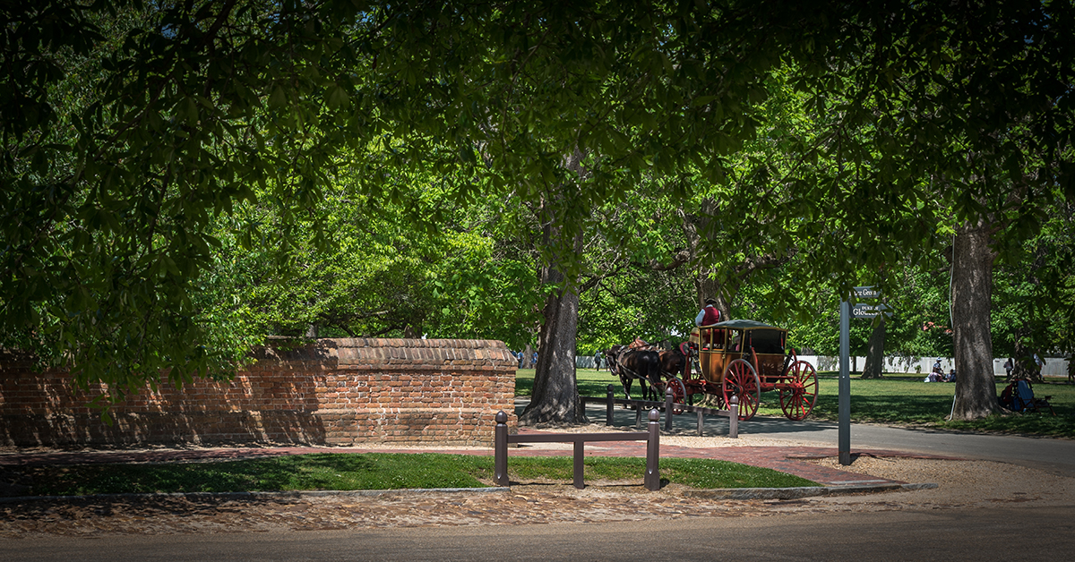 Horse-drawn-carriage-traveling-down-road-Williamsburg-Virginia