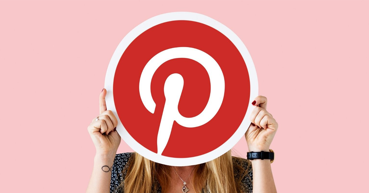 woman-holding-sign-with-Pinterest-logo-in-front-of-her-face