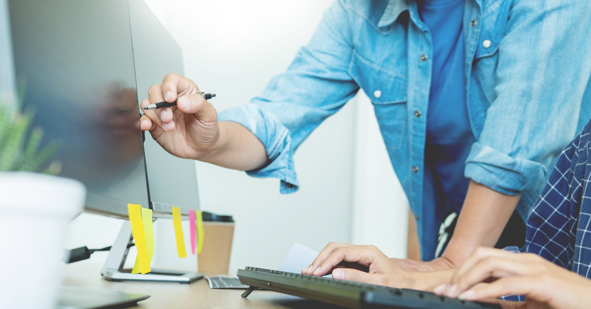 person-pointing-at-computer-screen