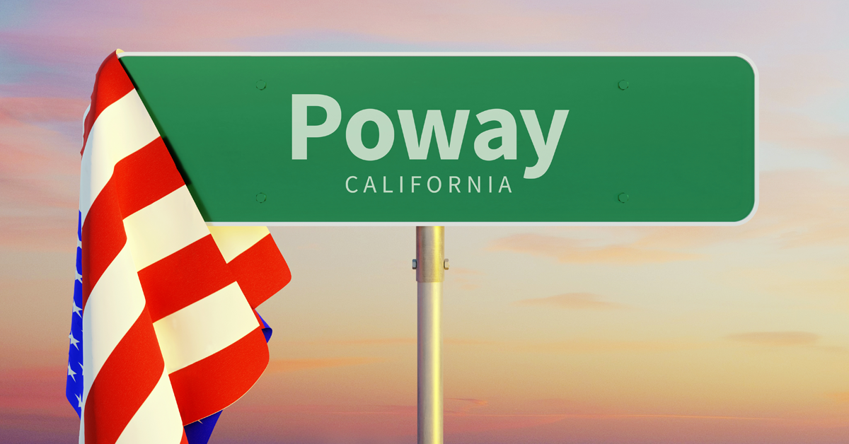 sign-that-reads-poway-california-with-american-flag-hanging-off-the-side