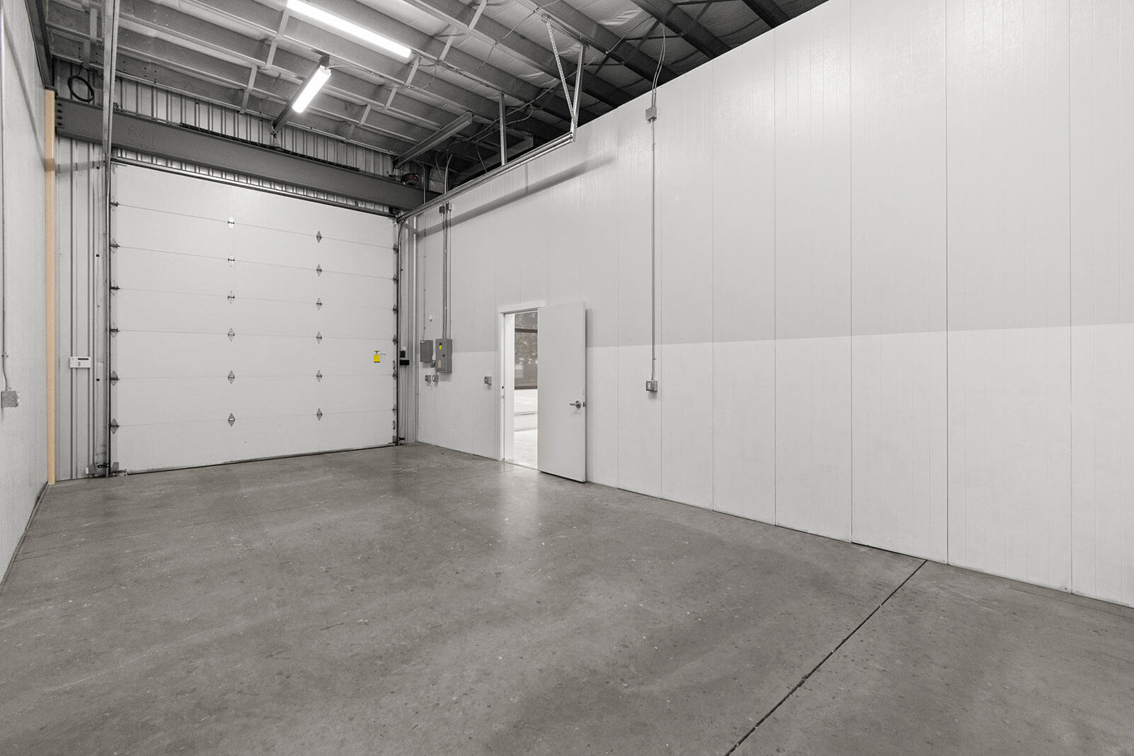 Open industrial space with closed garage door