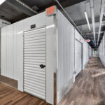 storage facility hallway with white roll-up doors